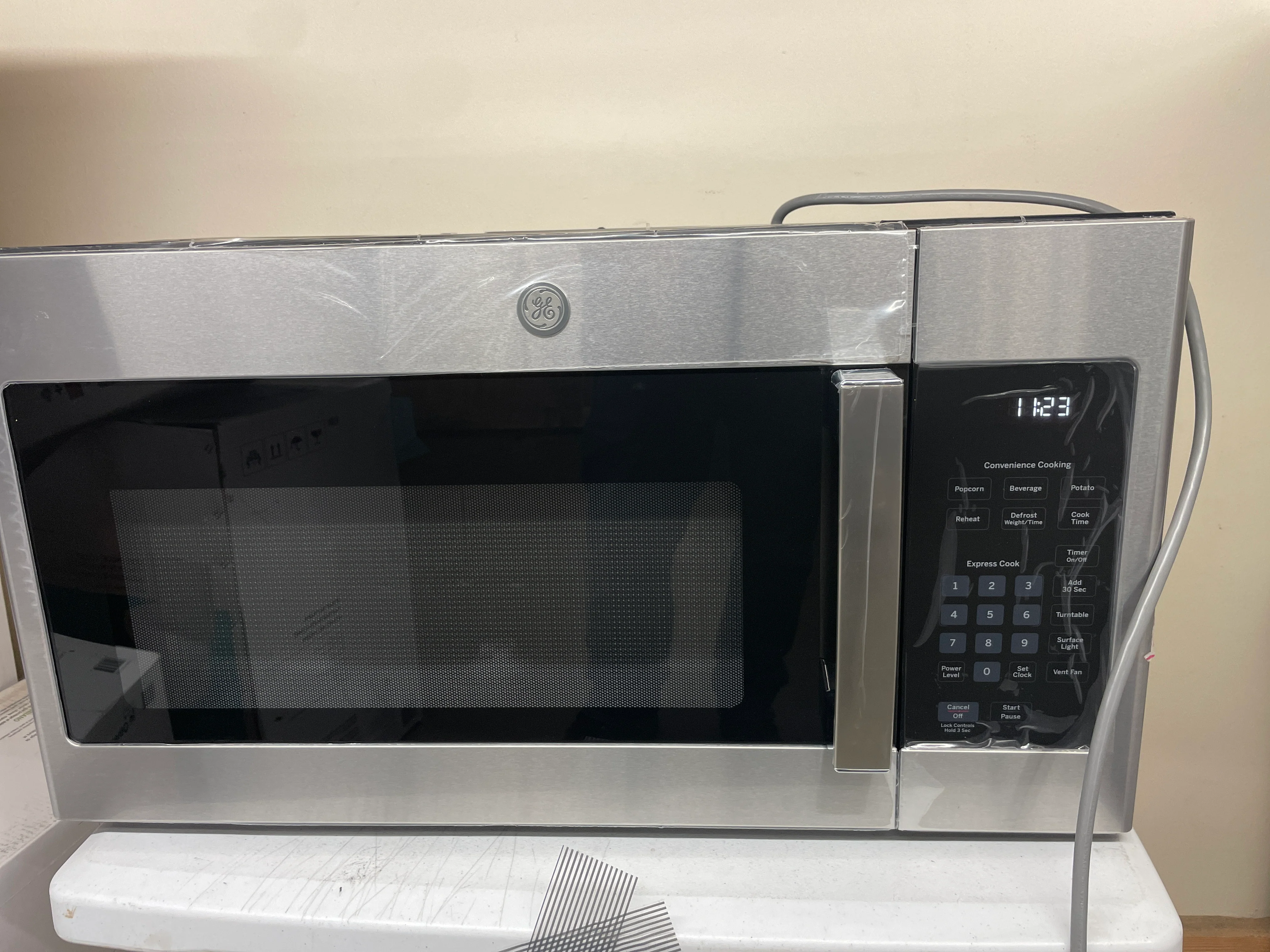 NEW - GE 1.6 cu. ft. Over-the-Range Microwave Oven with Cooktop Lighting and 300-CFM Exhaust Fan JVM3160RFSS - Retail $359 - Image 5
